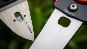 Close-up of bypass and anvil secateur blades showing cutting mechanism differences, professional garden tool photography with sharp focus on blade design